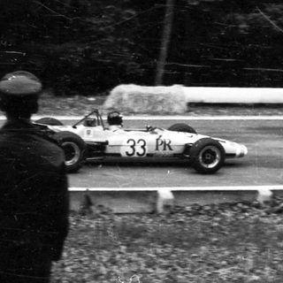 Race car driving on wet track.