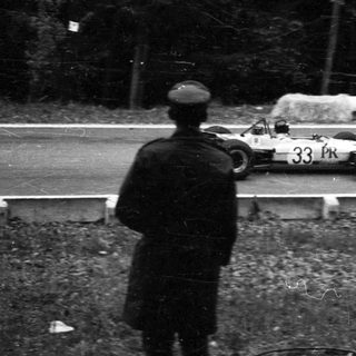Race car driving on wet track.