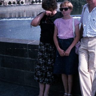 Family posing by Prague's Charles Bridge.