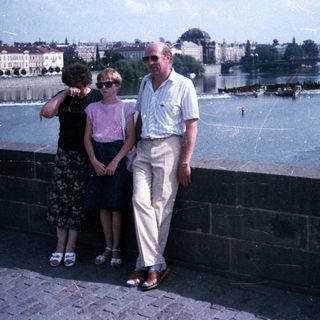 Family posing by Prague's Charles Bridge.