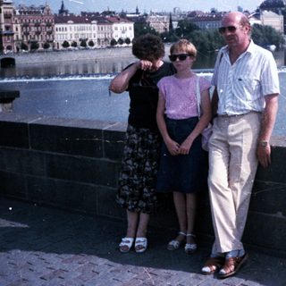 Family posing by Prague's Charles Bridge.