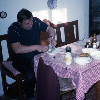 Two people eating breakfast at a vintage table.