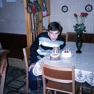 A young boy blowing out birthday candles on a cake.