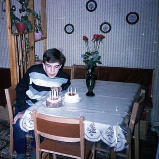 A young boy blowing out birthday candles on a cake.