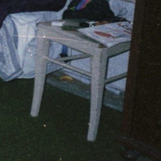 Three people studying together in a dorm room.