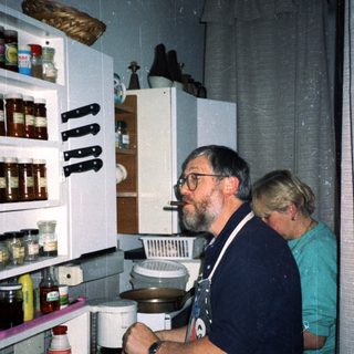 Two people preparing food in a kitchen.