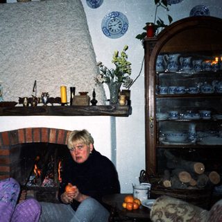 Cozy indoor scene with couple by fireplace.