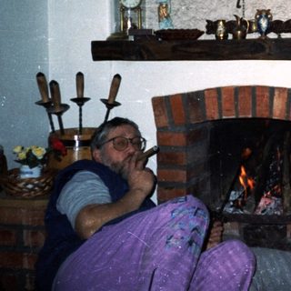Cozy indoor scene with couple by fireplace.