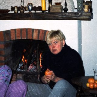 Cozy indoor scene with couple by fireplace.