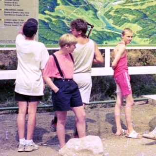Group of people examining Spindlerův Mýt ski resort maps.