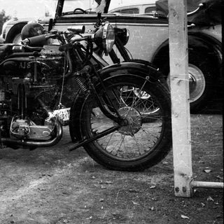 Vintage motorcycle with sidecar components, early 20th century.