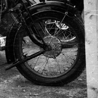 Vintage motorcycle with sidecar components, early 20th century.