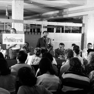 Public lecture or meeting with speaker addressing audience.