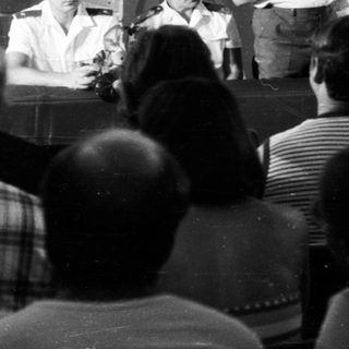Public lecture or meeting with speaker addressing audience.