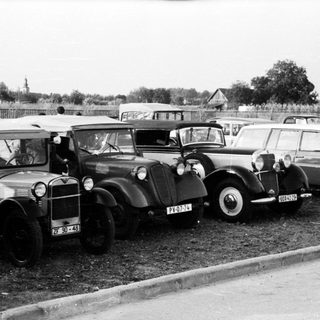 Vintage cars parked in a lot.