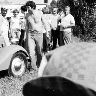 Classic rally car with vintage audience.