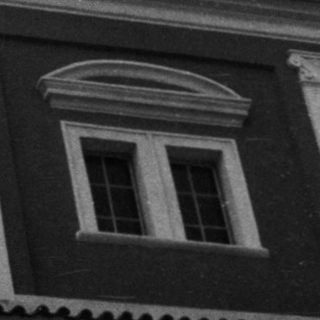 Neoclassical building facade with decorative columns.