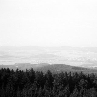 Panoramic view of forested hills and distant valley.