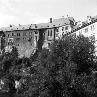Historic castle perched on rocky riverbank.