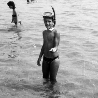 Children playing in shallow ocean water.