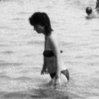 Children playing in shallow ocean water.