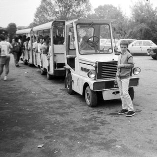 Vintage minibus parked with people boarding.