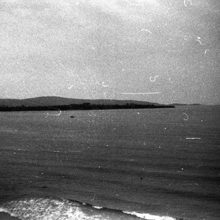 Coastline with calm ocean waves.