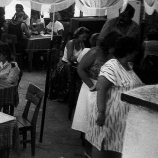 Outdoor buffet event with people serving food.