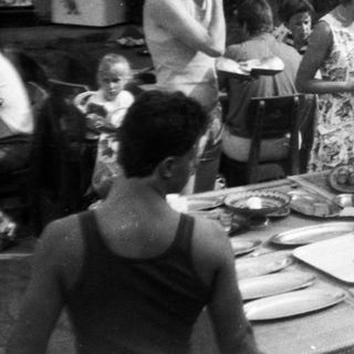Outdoor buffet event with people serving food.