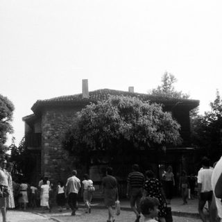 People gathered outside a historic stone building.