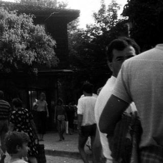 People gathered outside a historic stone building.