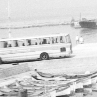 Boats docked along a misty riverbank.