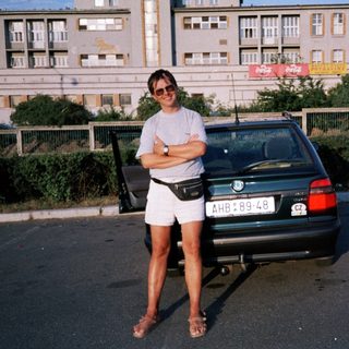 Person posing by vintage BMW car.
