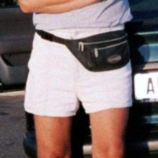 Person posing by vintage BMW car.