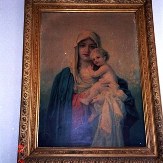 "Religious painting of Virgin Mary holding baby Jesus."