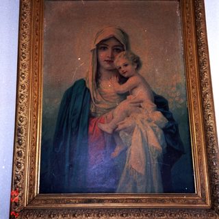 "Religious painting of Virgin Mary holding baby Jesus."