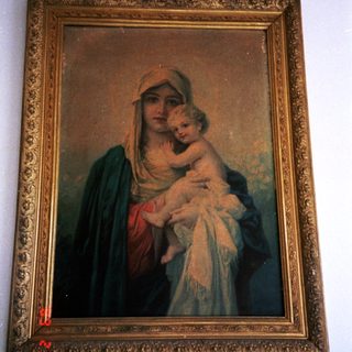 "Religious painting of Virgin Mary holding baby Jesus."