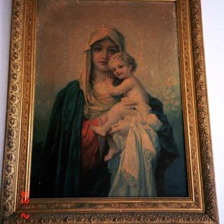 "Religious painting of Virgin Mary holding baby Jesus."