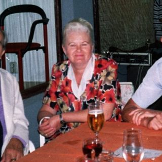Four people dining together indoors at night.
