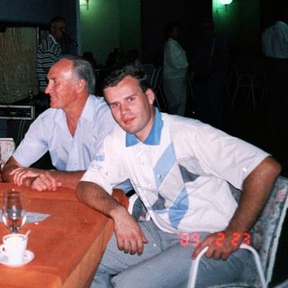 Four people dining together indoors at night.
