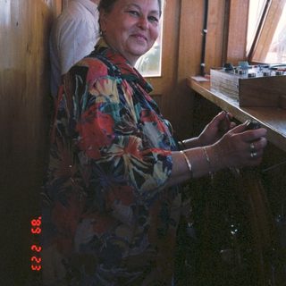 Two people in a vintage train cabin. Woman operating controls.