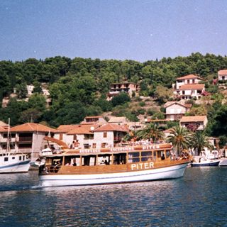 Coastal town with boats and Mediterranean-style buildings.