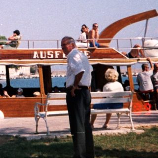 Boat named "Piter" offering excursions near coastal town.