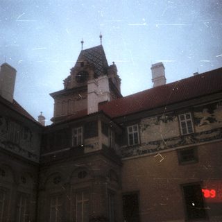 Historic building with ornate facade, rainy night.