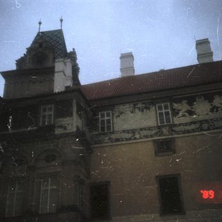 Historic building facade with ornate stonework, night view.