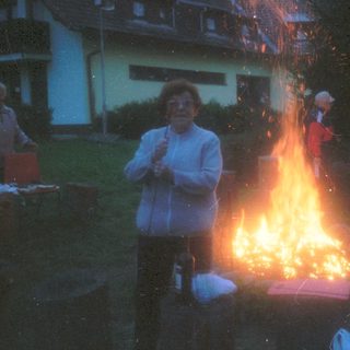 Group gathered around evening bonfire.
