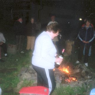 People gathered around a campfire at night.