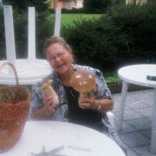 Woman enjoying outdoor meal with mushrooms.