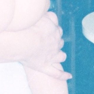 A woman holding a baby indoors.
