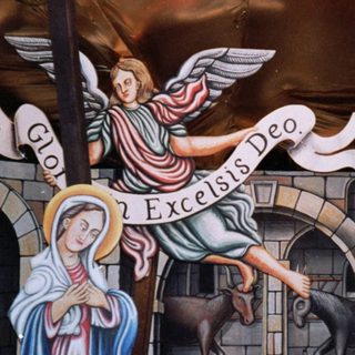 Depiction of Nativity scene with angel announcing birth.